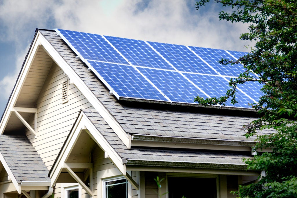 Solar panels offering green home upgrades on a house undergoing construction