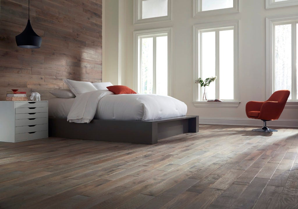oak covers the floors and walls in this contemporary bedroom