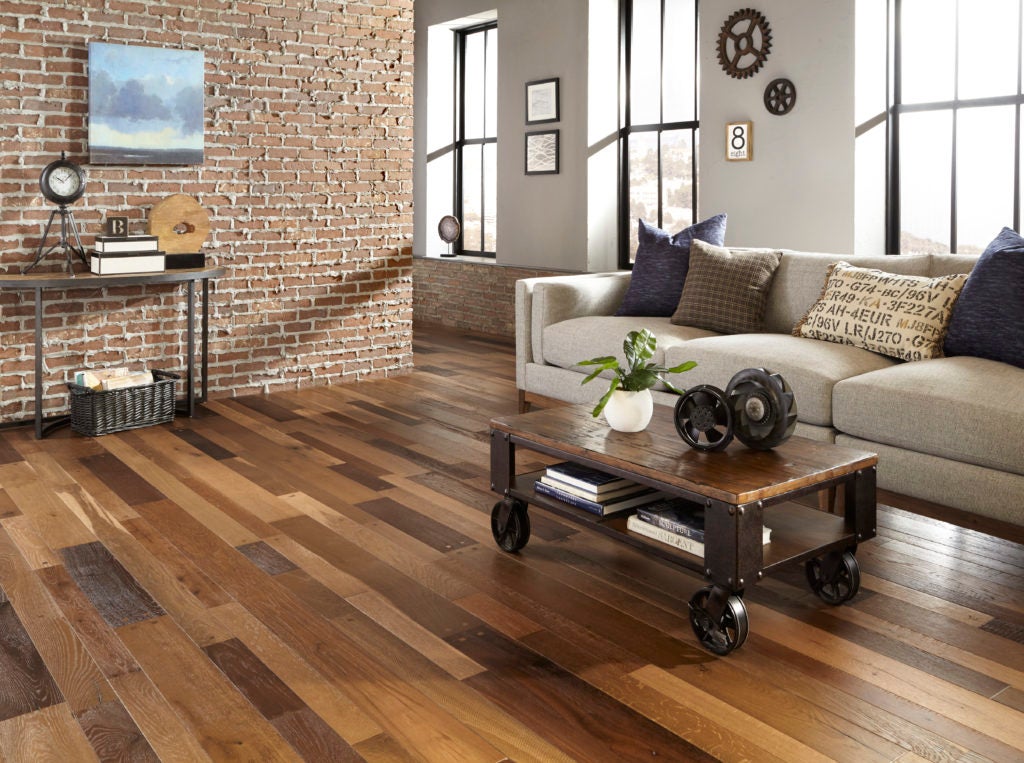 Industrial living room with brick and metal accents with engineered oak floors.