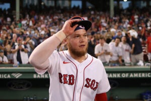 Alex Verdugo tips his hat to fans in a crowded Fenway Park