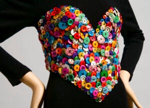 Dress with corset top covered in colorful buttons.