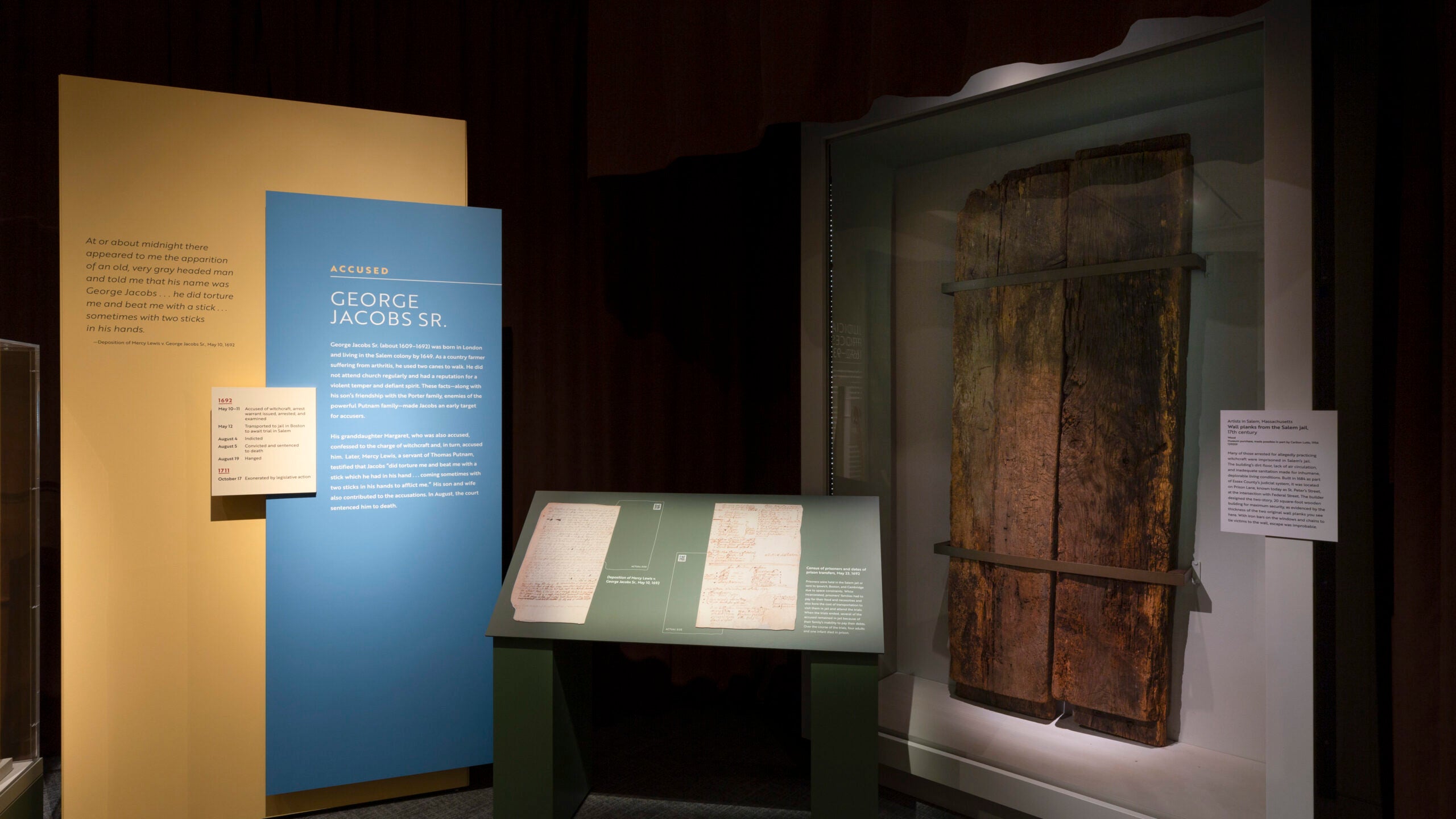 An exhibit at the Peabody Essex Museum that contains a large, wooden door with information about it on the left. 