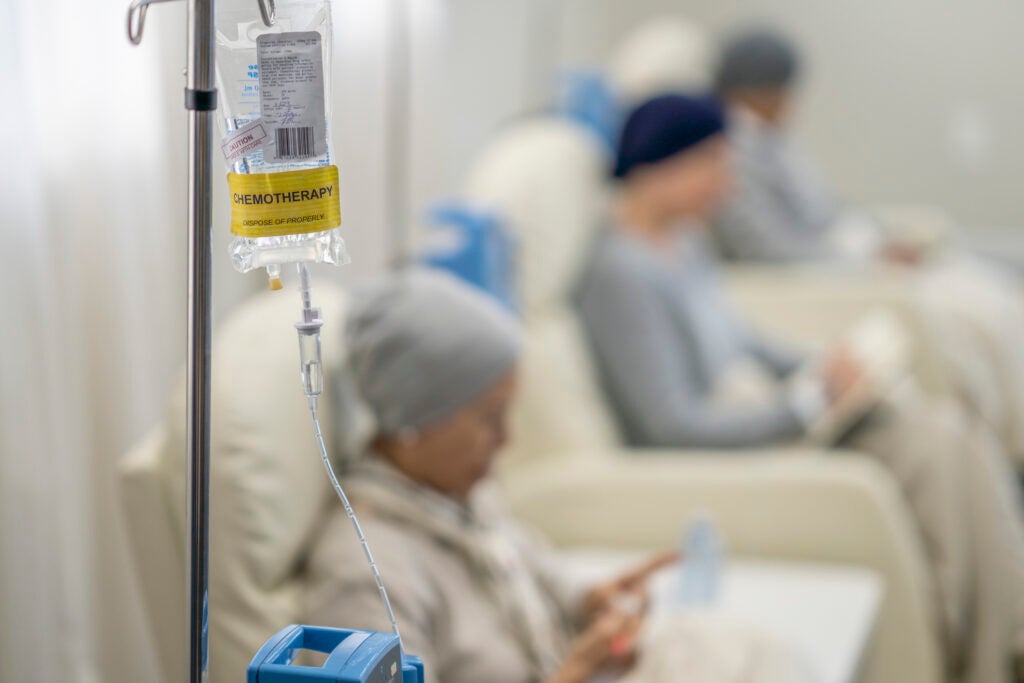 Three women sit in individual chairs as they receive their Chemotherapy by intravenous.  