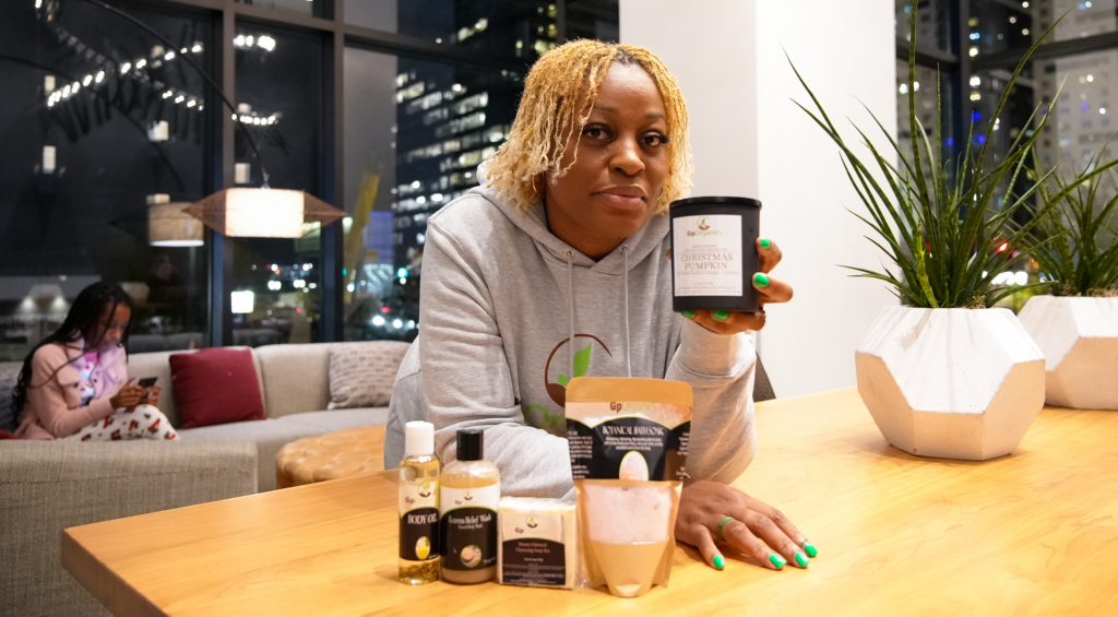 Gina shows us her collection of handcrafted care products while the background is the bright, welcoming lobby of The Watermark.