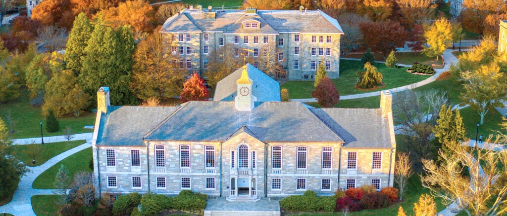 Aerial view of a New England university campus in the fall, featuring green spaces and historical buildings.