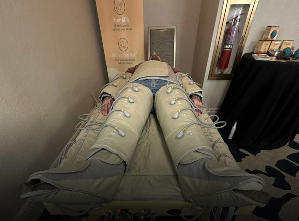 A patient laying in a full-body wellness suit that monitors his heart rate and sleeping patterns.