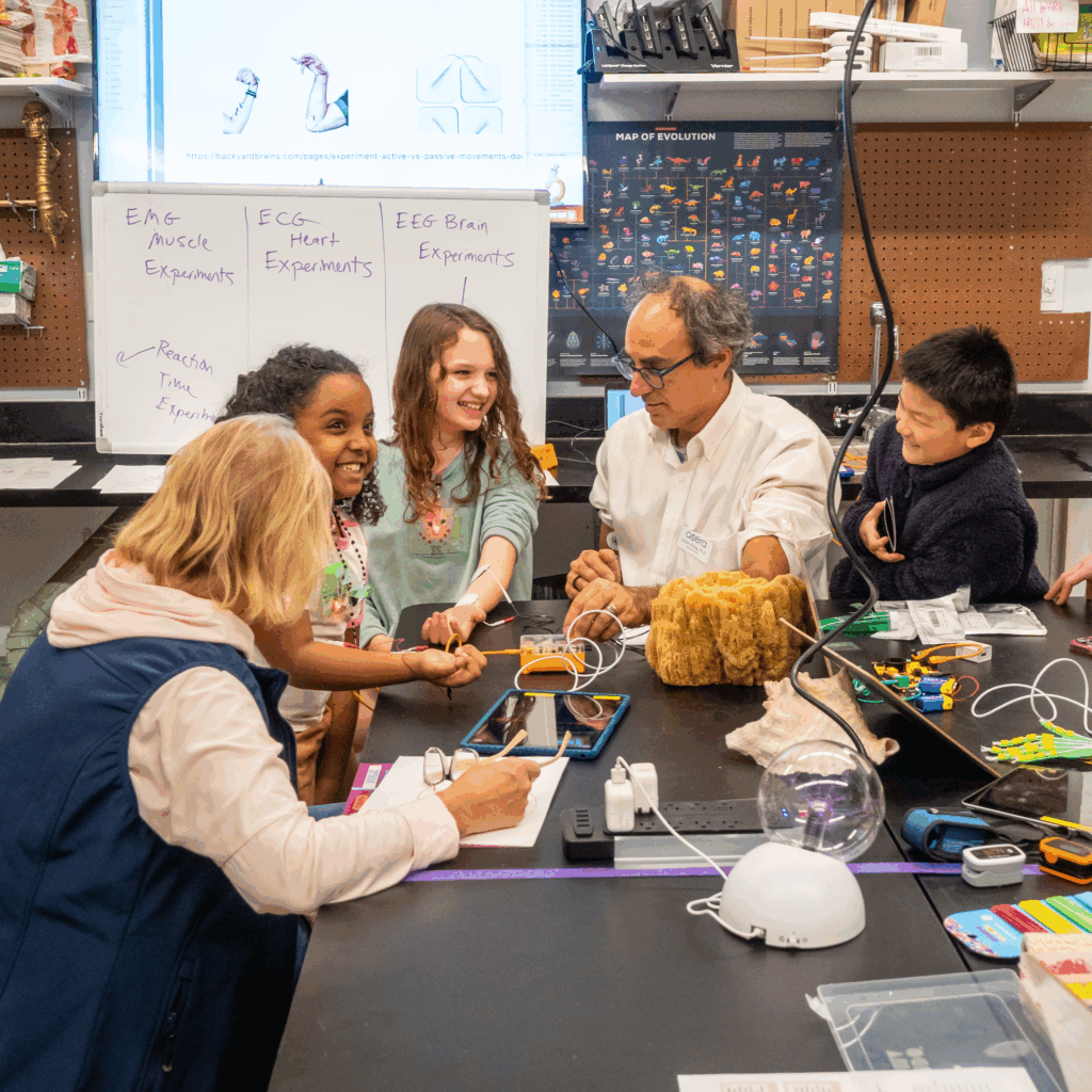 Group of students discussing with their professor 