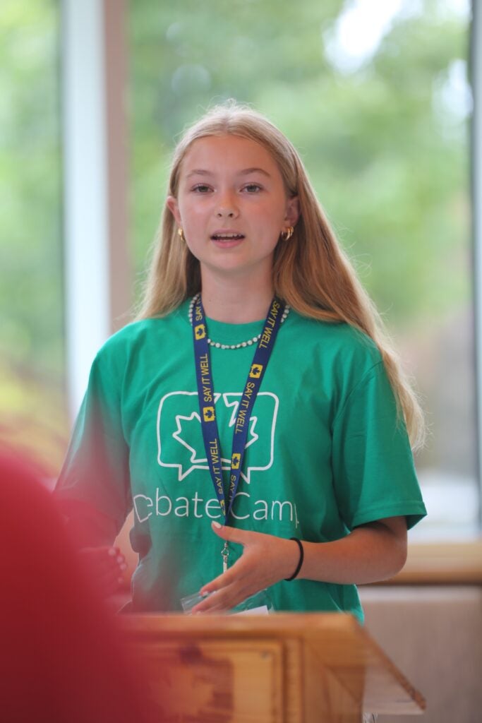 Young camper speaking in front of a crowd 