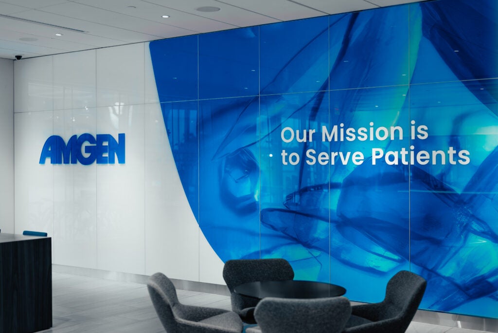 Amgen's logo in a lobby with the company's mission statement