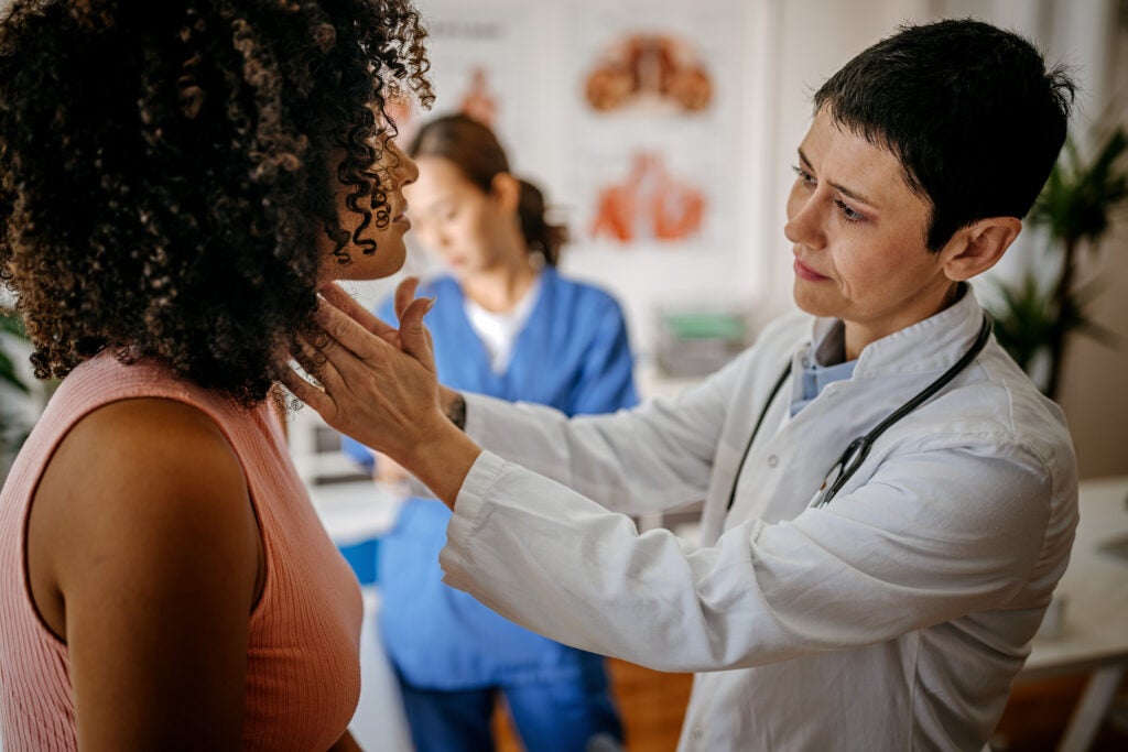 Doctor examining a patient in her medical office 