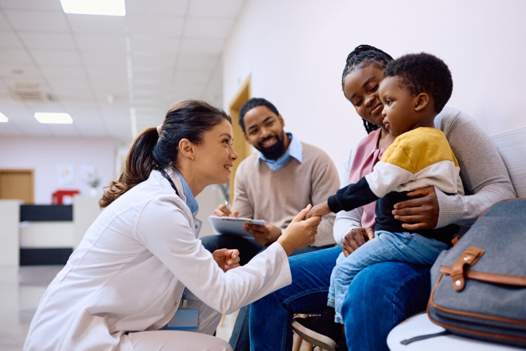 Doctor holding hand on boy at a pediatric clinic