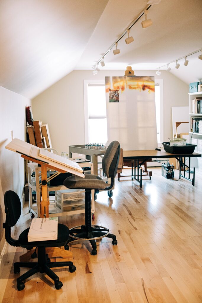 Wooden room with large canvases and art utensils