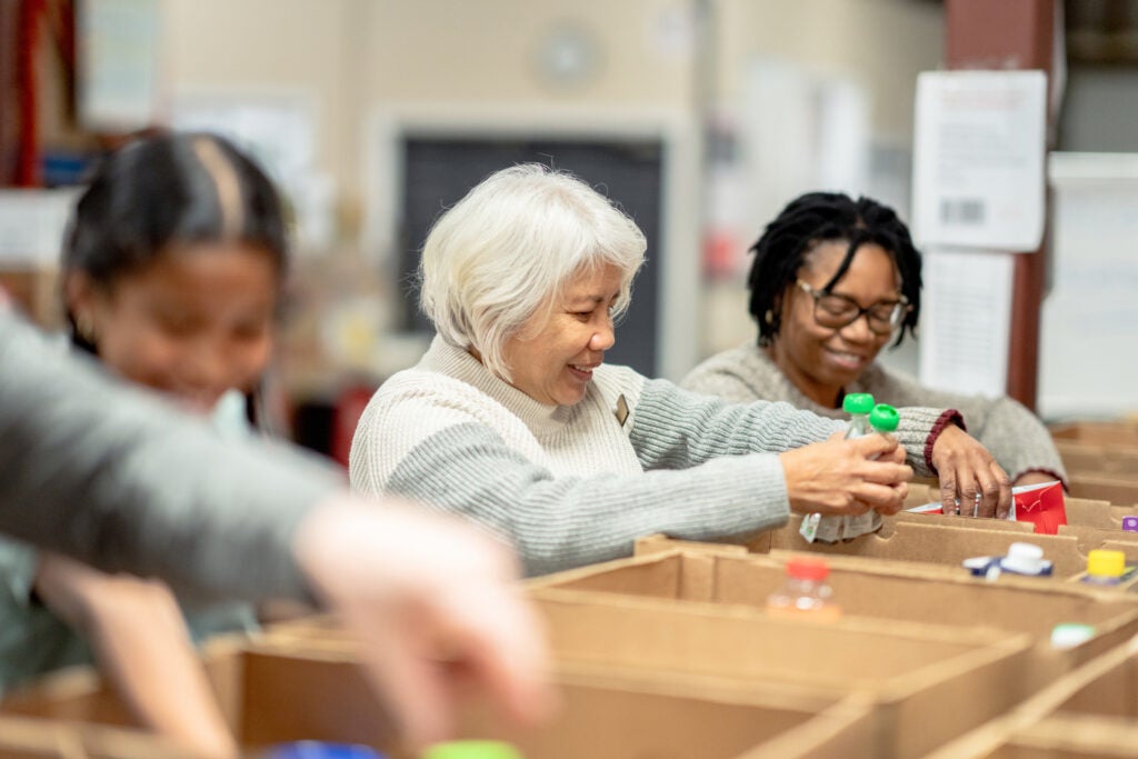 Volunteers putting food inside boxes