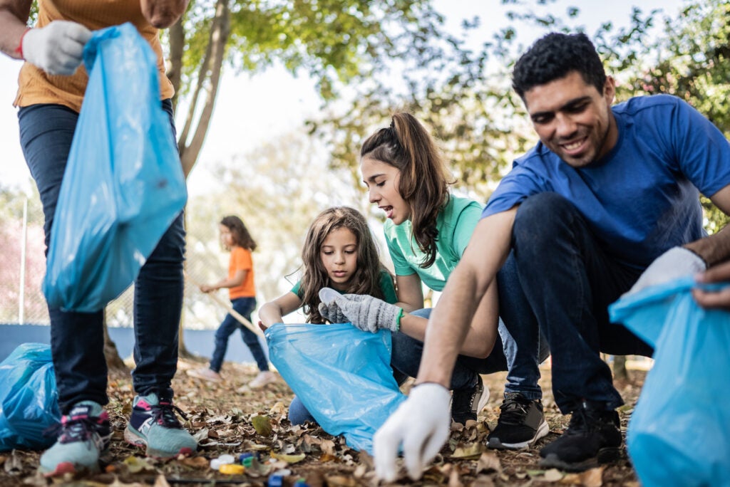 People picking up garbage to clean a park