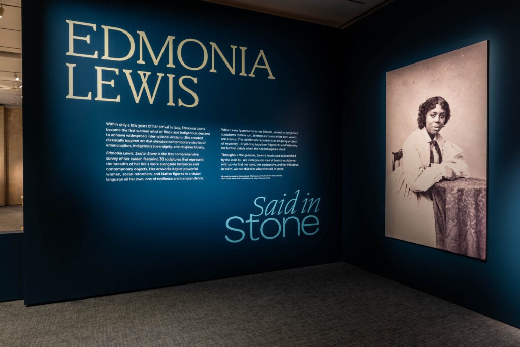 Blue museum wall with photo and information about Edmonia Lewis