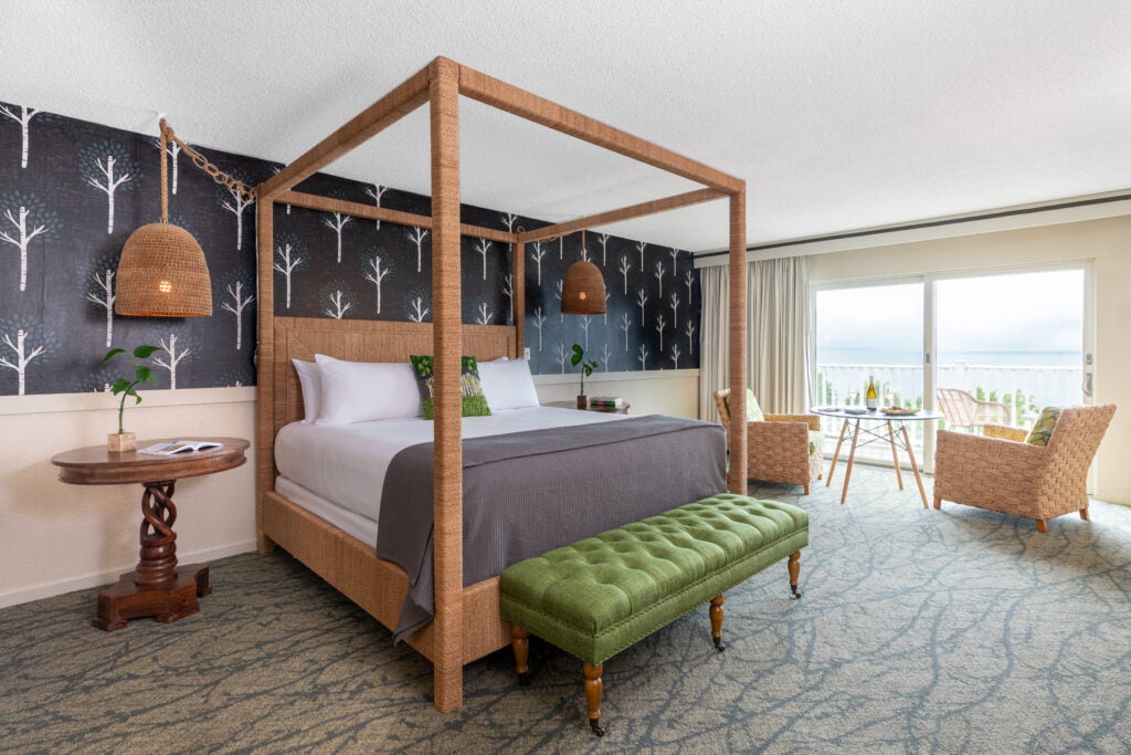 Hotel bedroom with a king-sized bed and a private balcony